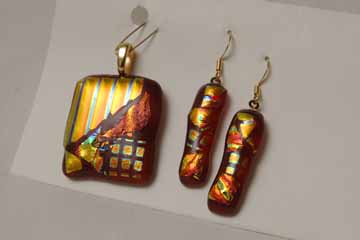 Red and golden earrings and matching pendant